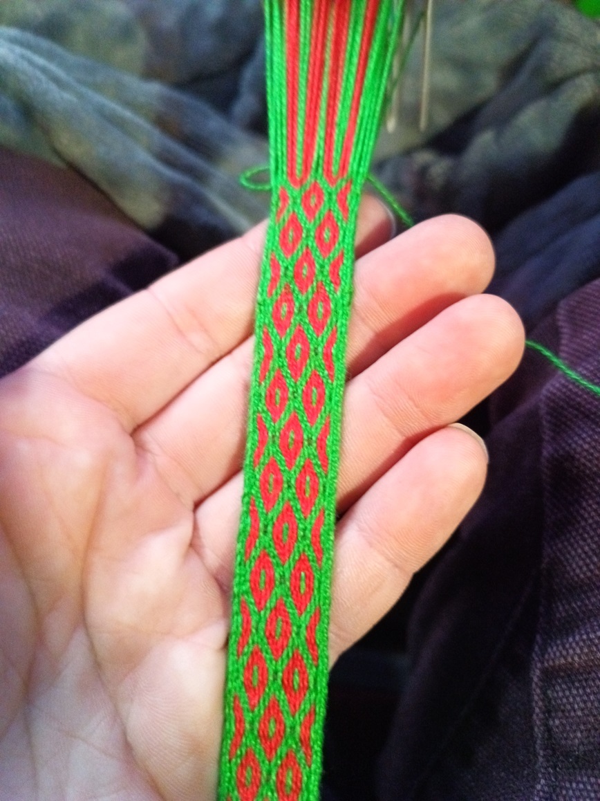 A small band with bright green borders and little red circles.