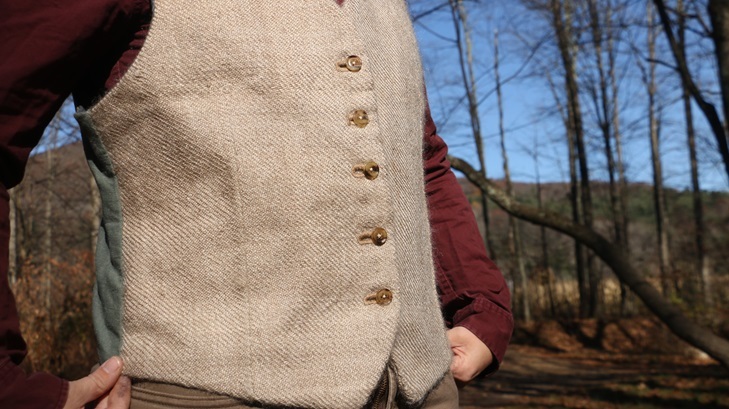 A shiny tan waistcoat being worn, it is a little large but pretty.