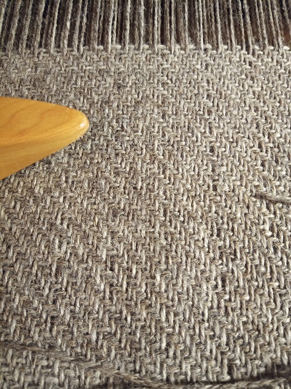 A grey simple twill woven cloth fills most of the picture.